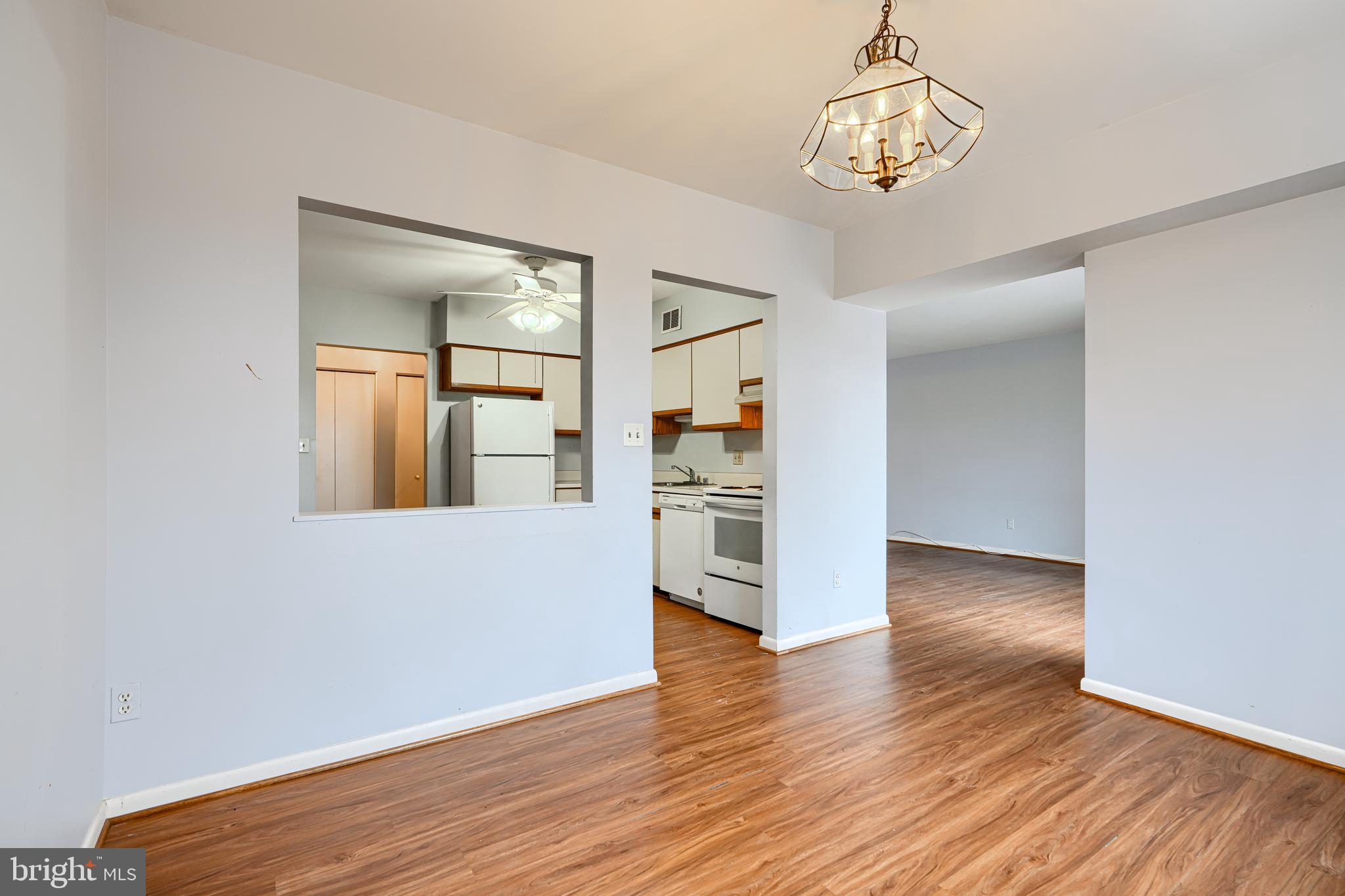 110 Castletown Road, Unit 201 Lutherville-Timonium, MD 21093 - Photo 12 of 41 a view of a kitchen with wooden floor and a refrigerator
