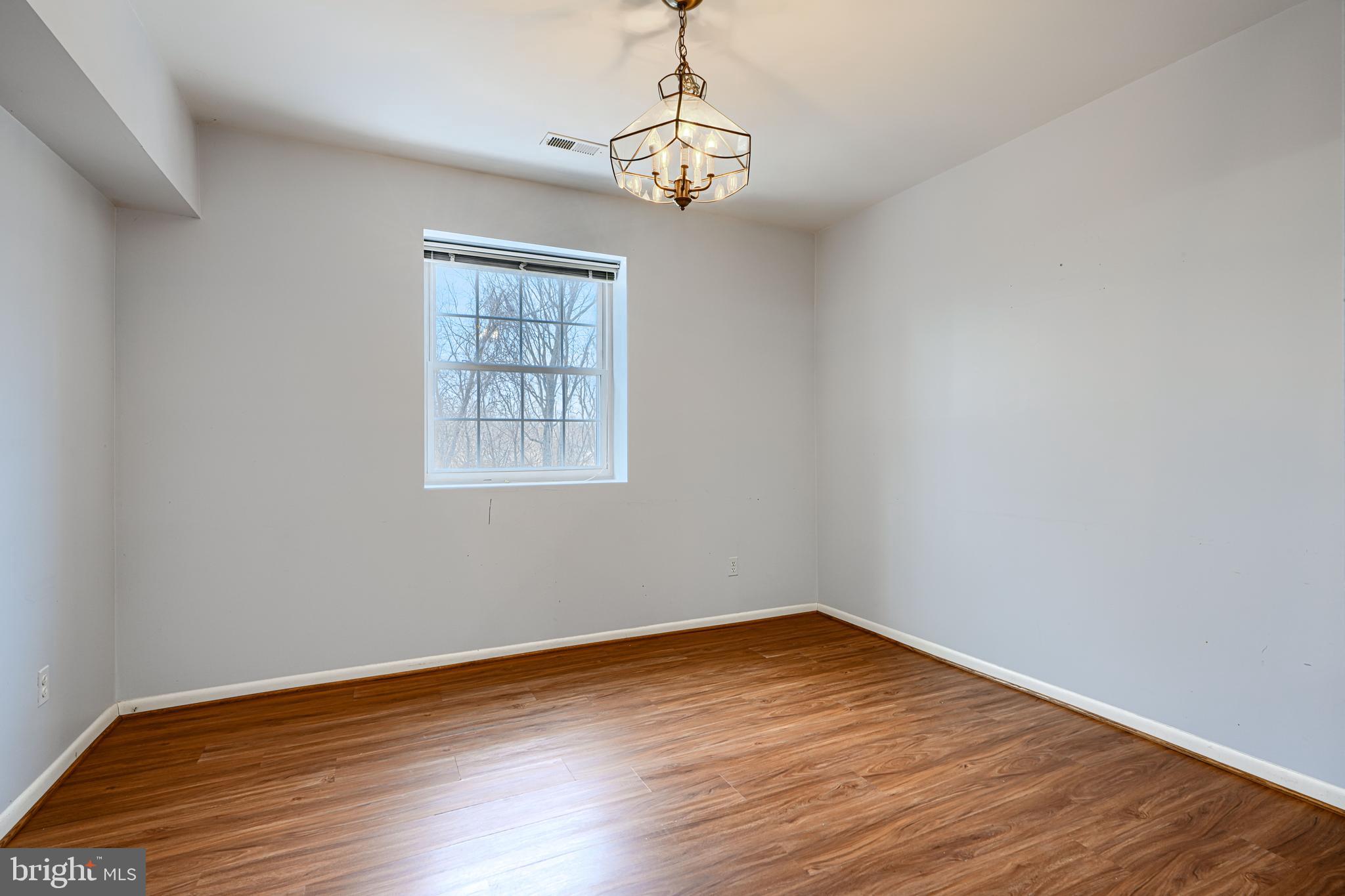 110 Castletown Road, Unit 201 Lutherville-Timonium, MD 21093 - Photo 14 of 41 a view of empty room with wooden floor and fan