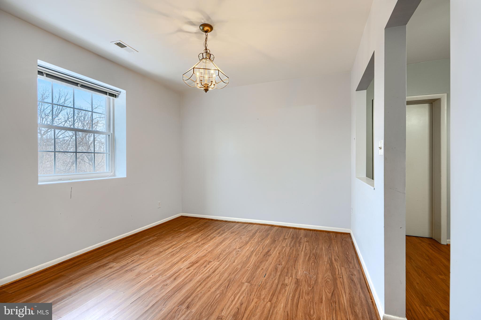 110 Castletown Road, Unit 201 Lutherville-Timonium, MD 21093 - Photo 15 of 41 a view of a room with wooden floor and windows
