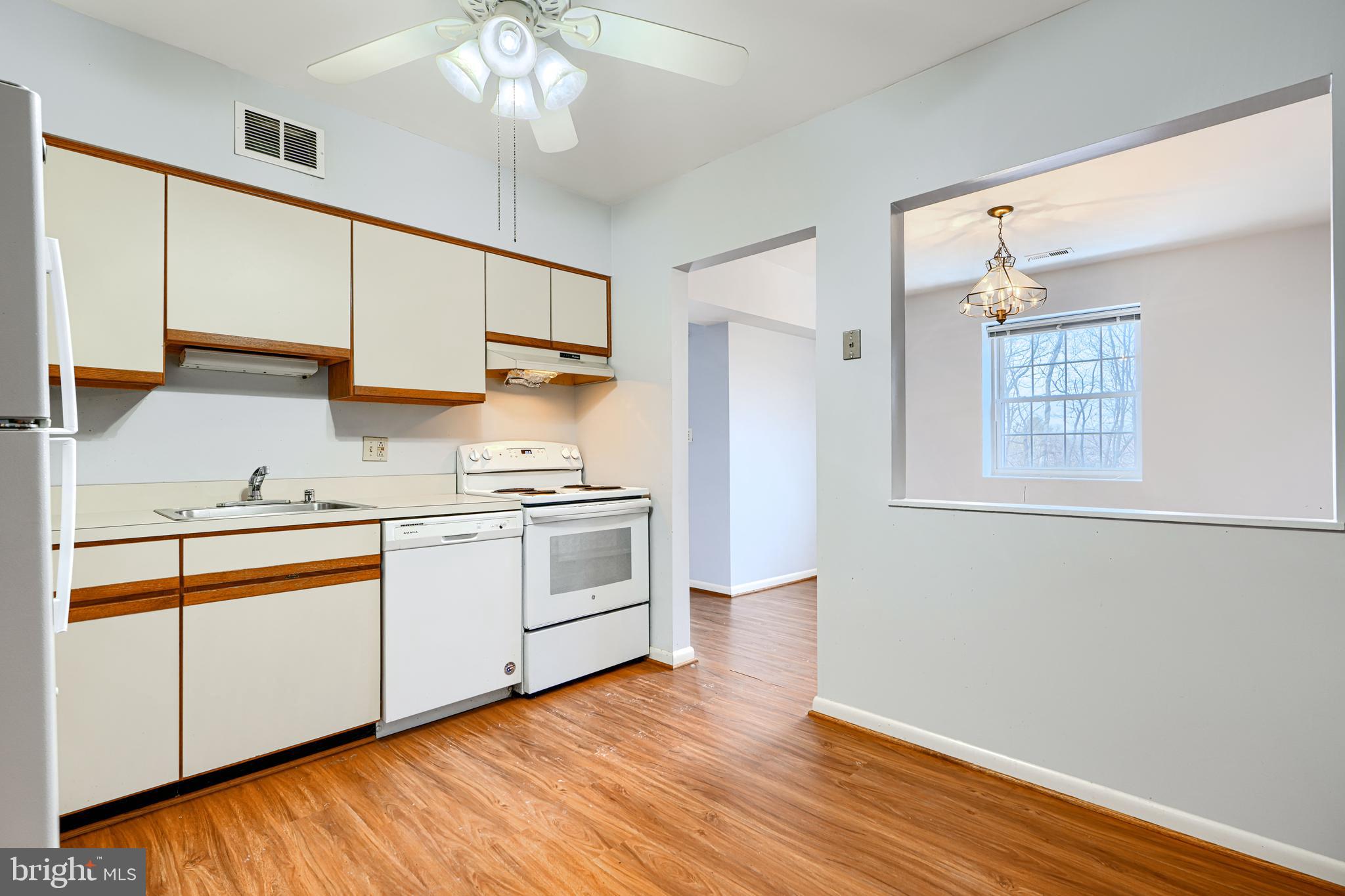 110 Castletown Road, Unit 201 Lutherville-Timonium, MD 21093 - Photo 16 of 41 a kitchen with a sink cabinets stainless steel appliances and a window