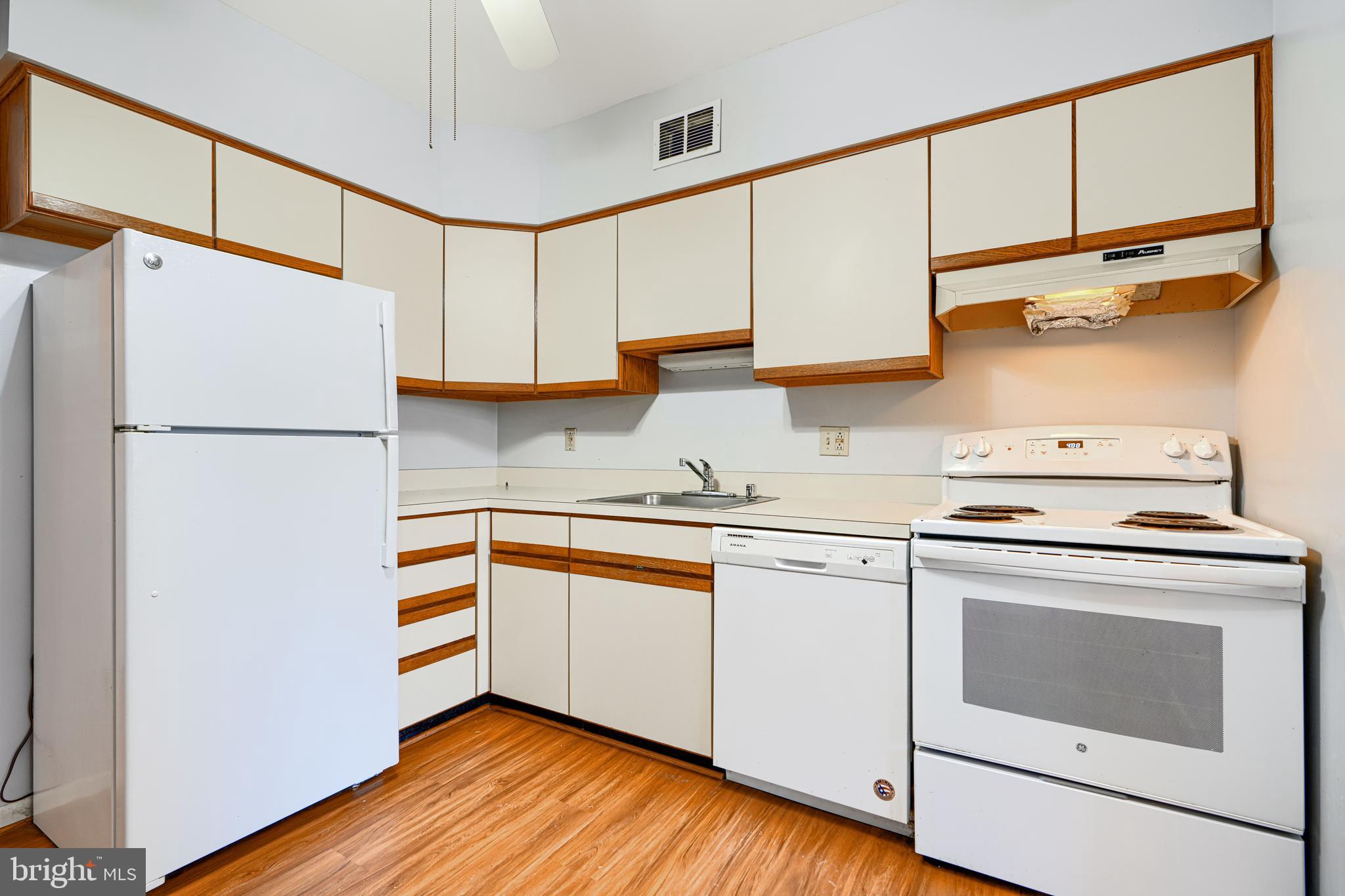 110 Castletown Road, Unit 201 Lutherville-Timonium, MD 21093 - Photo 18 of 41 a kitchen with granite countertop white cabinets and white appliances