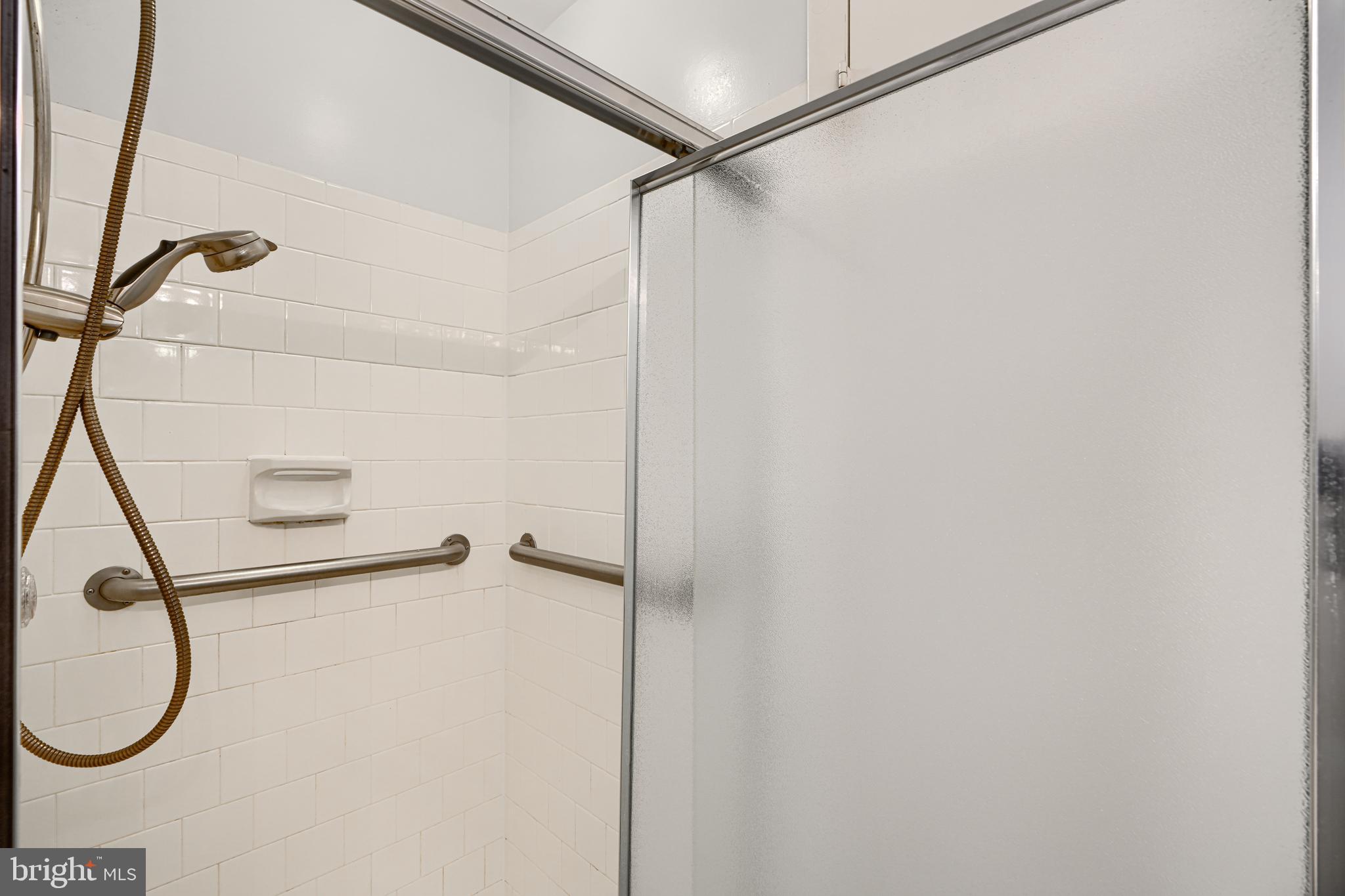 110 Castletown Road, Unit 201 Lutherville-Timonium, MD 21093 - Photo 27 of 41 a bathroom with a glass shower door