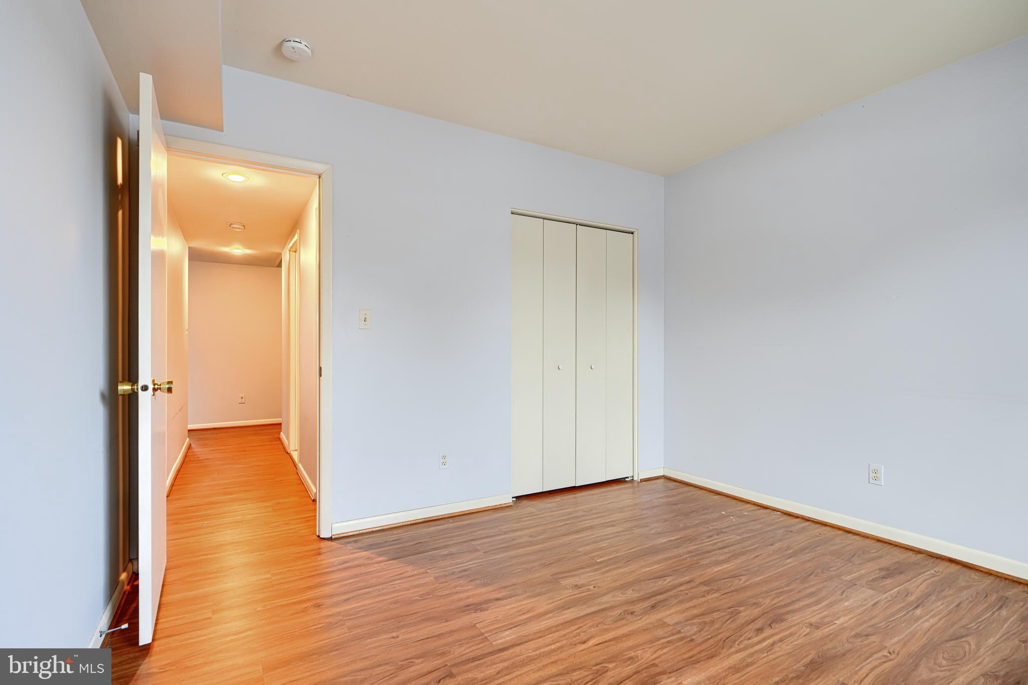 110 Castletown Road, Unit 201 Lutherville-Timonium, MD 21093 - Photo 30 of 41 a view of an empty room with wooden floor and a bathroom