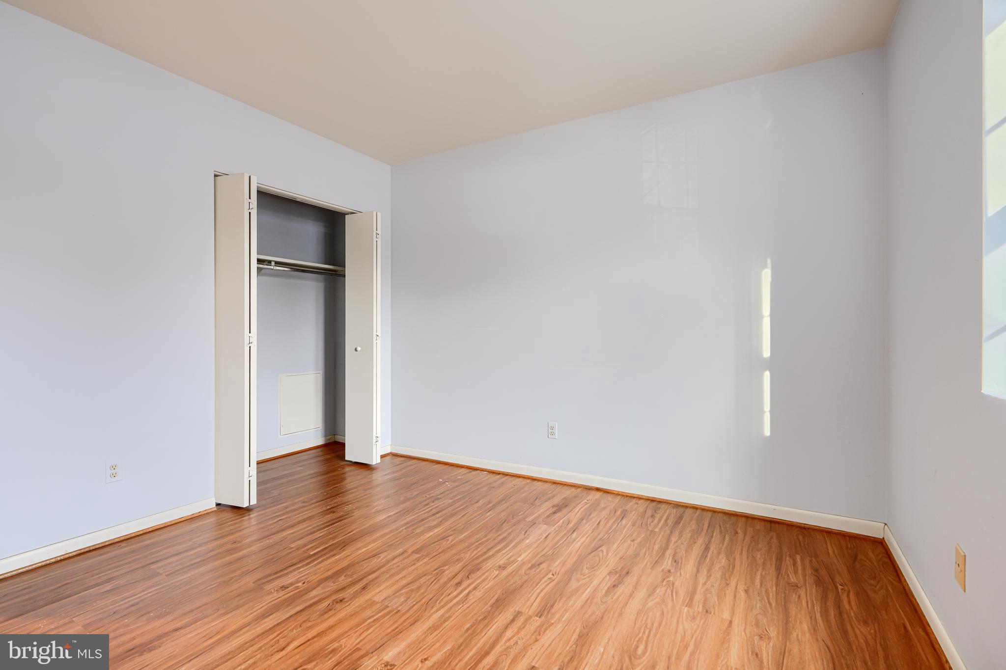 110 Castletown Road, Unit 201 Lutherville-Timonium, MD 21093 - Photo 31 of 41 an empty room with wooden floor and windows