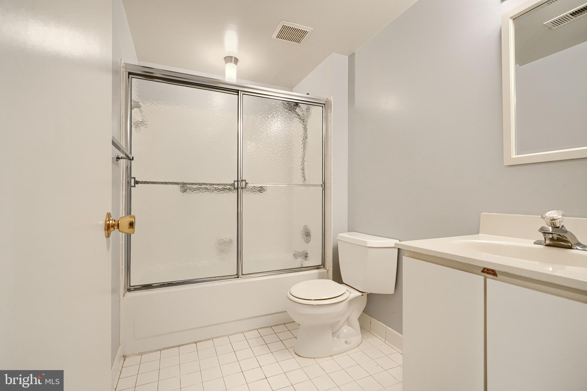 110 Castletown Road, Unit 201 Lutherville-Timonium, MD 21093 - Photo 32 of 41 a white toilet sitting next to a bathroom sink