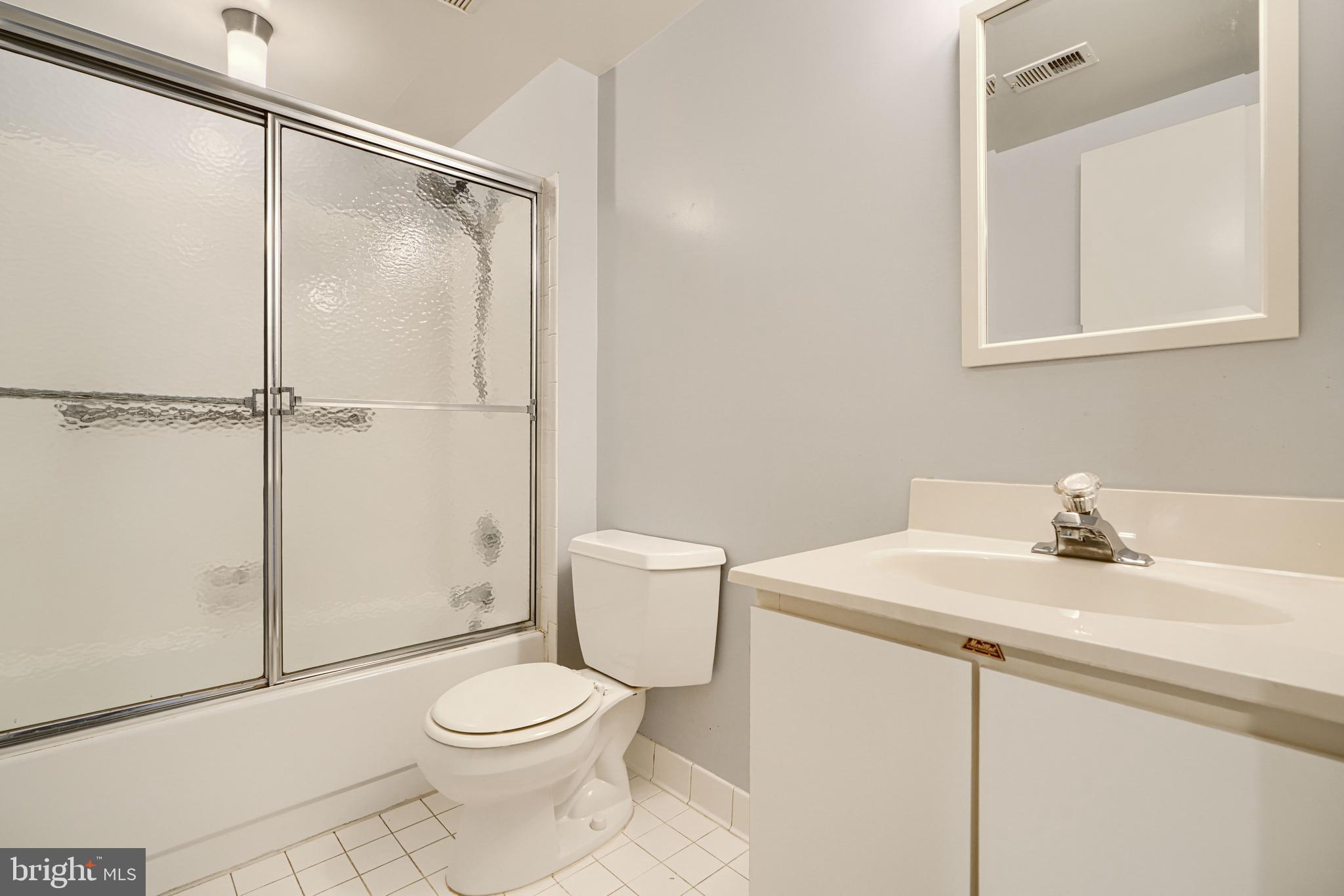 110 Castletown Road, Unit 201 Lutherville-Timonium, MD 21093 - Photo 33 of 41 a bathroom with a sink a toilet and shower