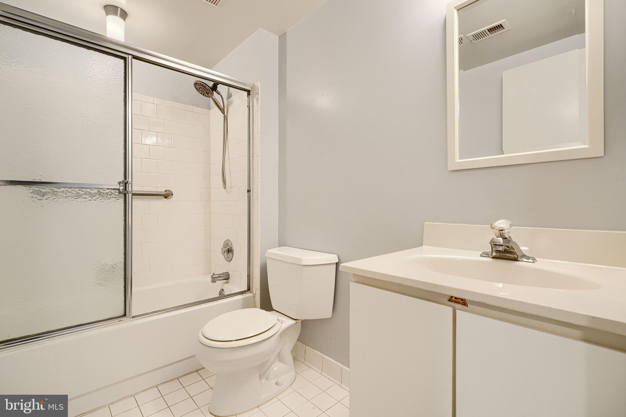 110 Castletown Road, Unit 201 Lutherville-Timonium, MD 21093 - Photo 34 of 41 a bathroom with a sink a toilet and shower
