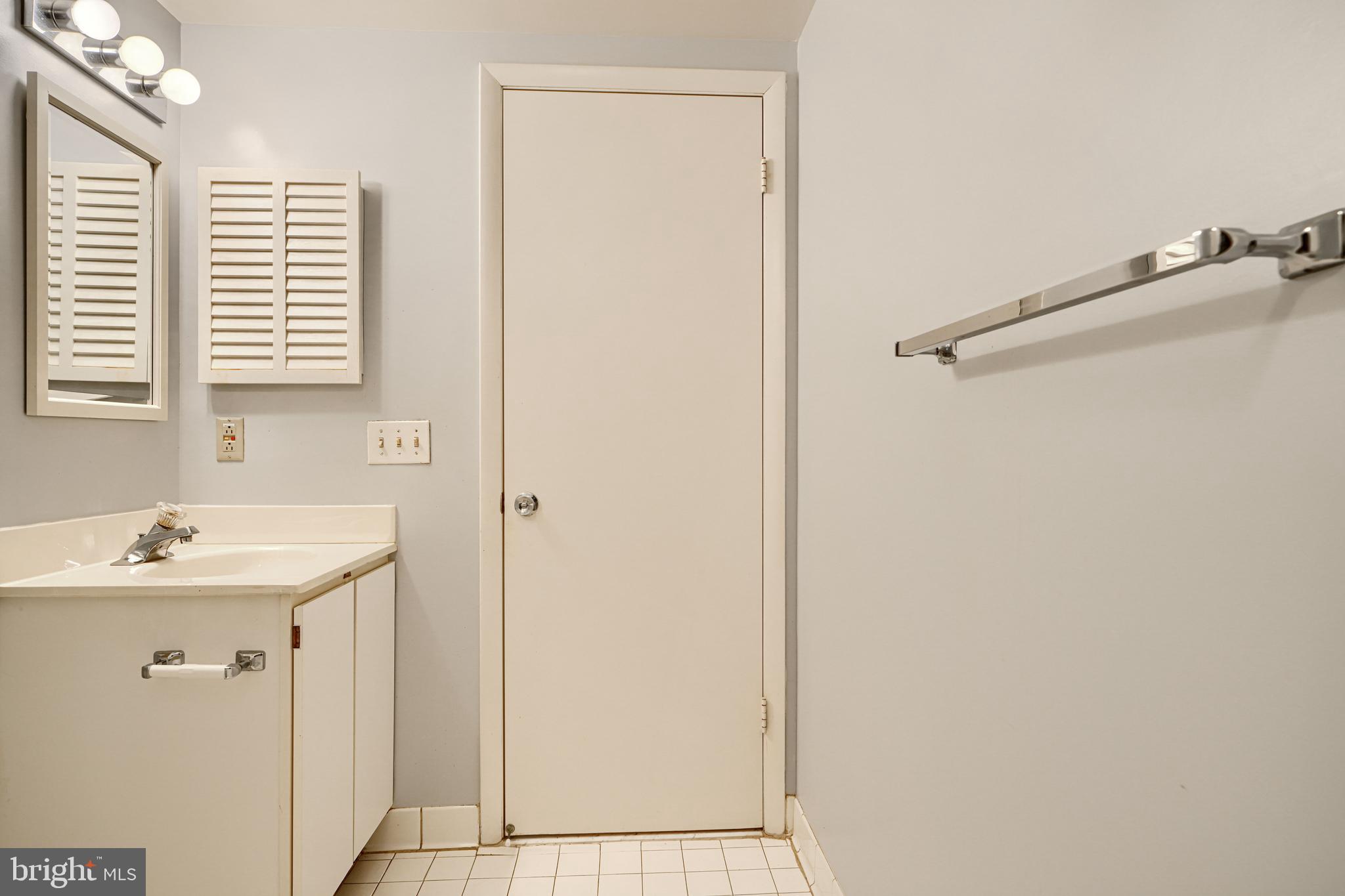 110 Castletown Road, Unit 201 Lutherville-Timonium, MD 21093 - Photo 36 of 41 a bathroom with a sink and a mirror