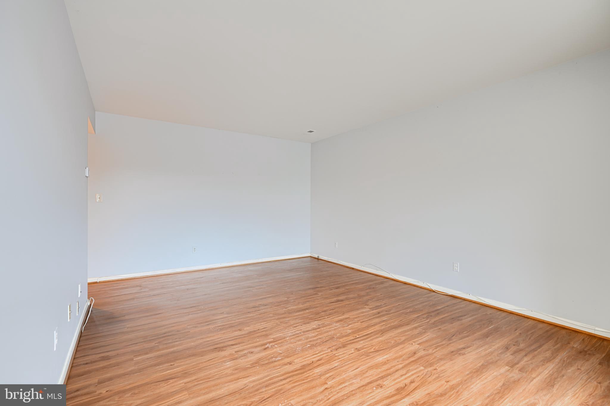 110 Castletown Road, Unit 201 Lutherville-Timonium, MD 21093 - Photo 6 of 41 a view of empty room with wooden floor
