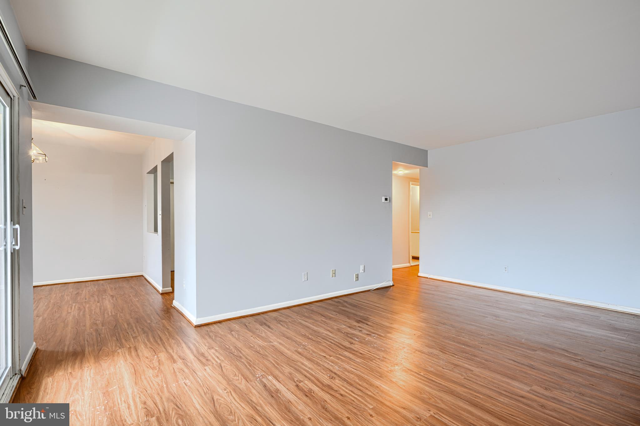 110 Castletown Road, Unit 201 Lutherville-Timonium, MD 21093 - Photo 7 of 41 a view of an empty room with wooden floor and a window