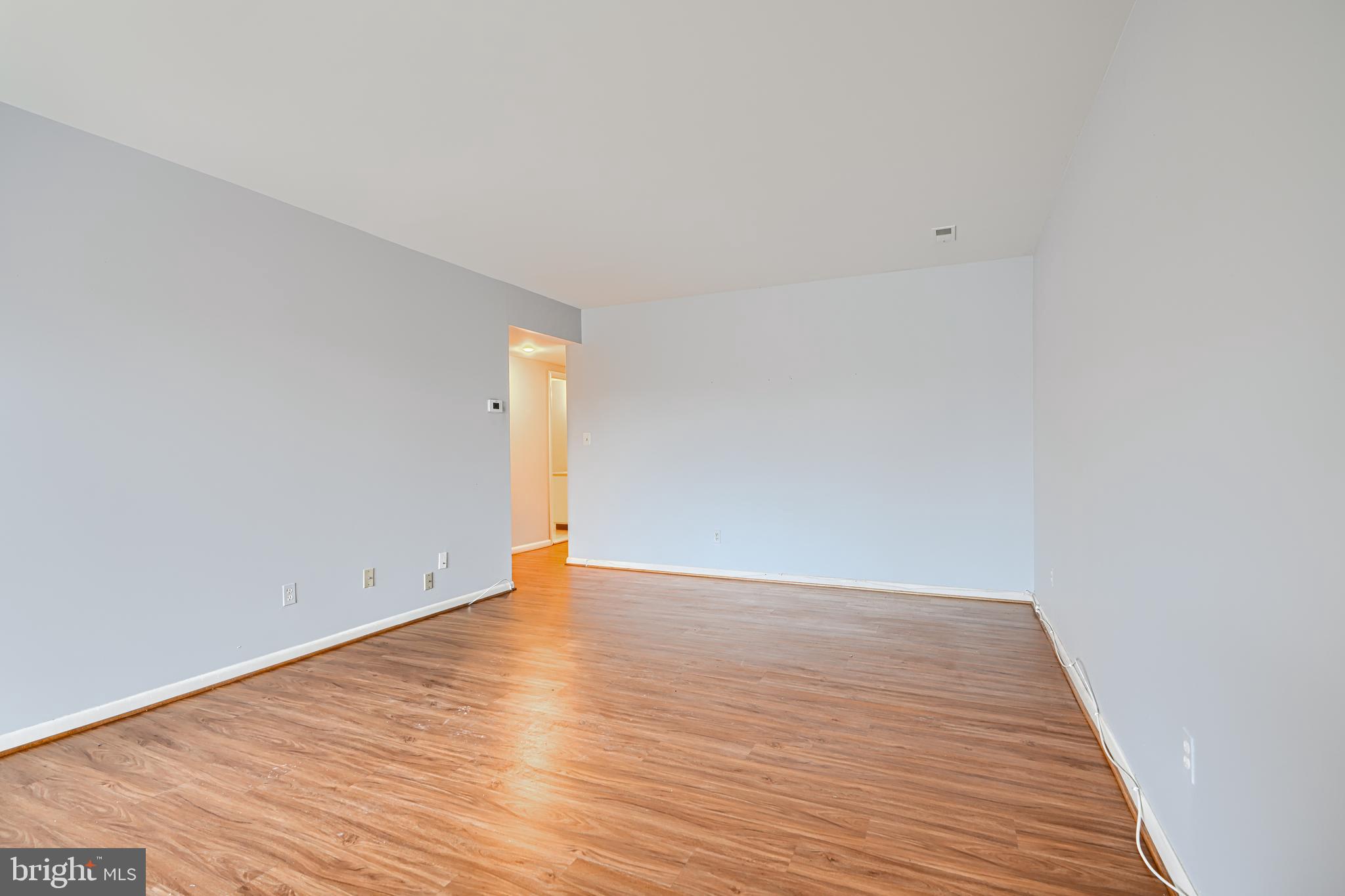 110 Castletown Road, Unit 201 Lutherville-Timonium, MD 21093 - Photo 8 of 41 a view of an empty room with wooden floor
