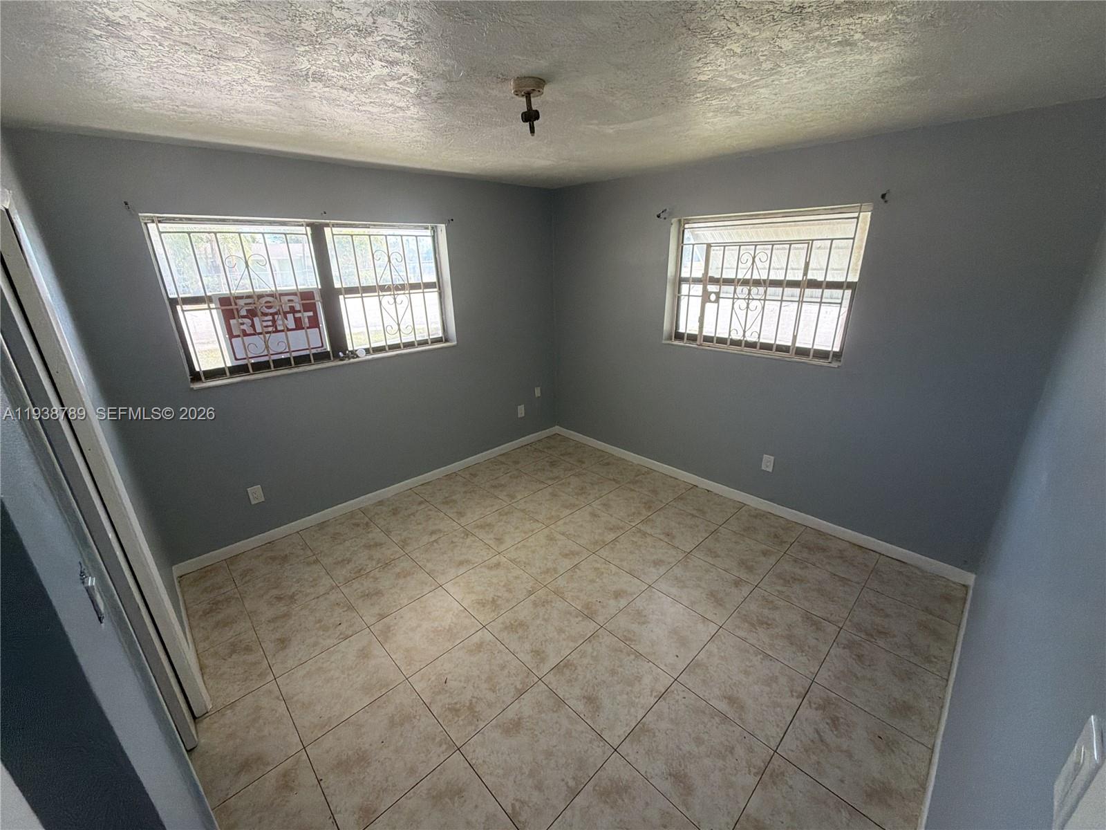 22192 Southwest 117th Avenue Miami, FL 33170 - Photo 3 of 6 an empty room with windows