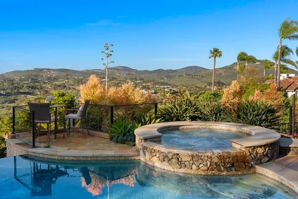 a view of a swimming pool with a table and chairs