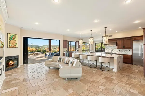 a living room with furniture a dining table and a fireplace