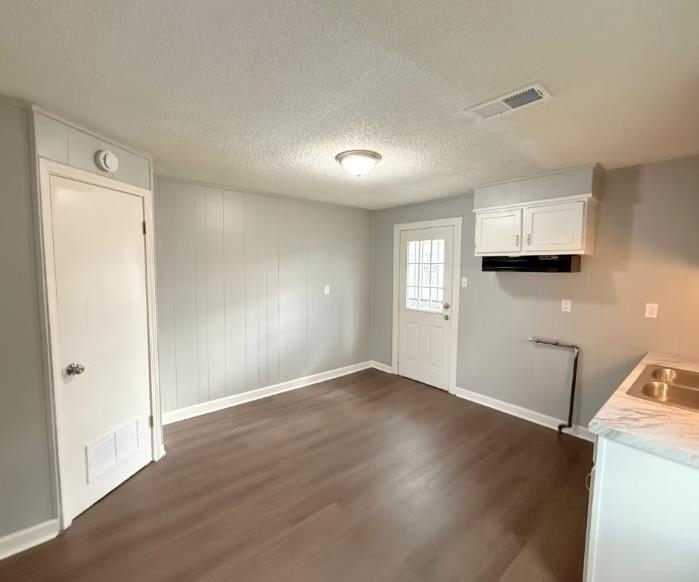 433 Dixie Road Memphis, TN 38109 - Photo 4 of 11 wooden floor in an empty room with a window
