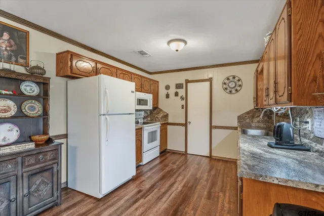 a kitchen with a refrigerator and a sink