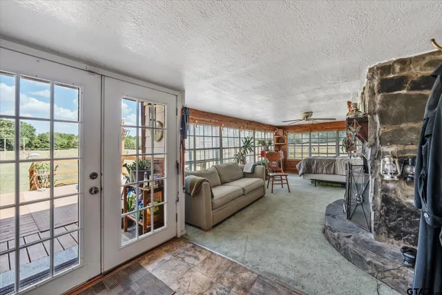 a living room with furniture and a floor to ceiling window