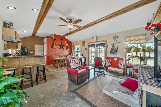 a living room filled with furniture and a chandelier