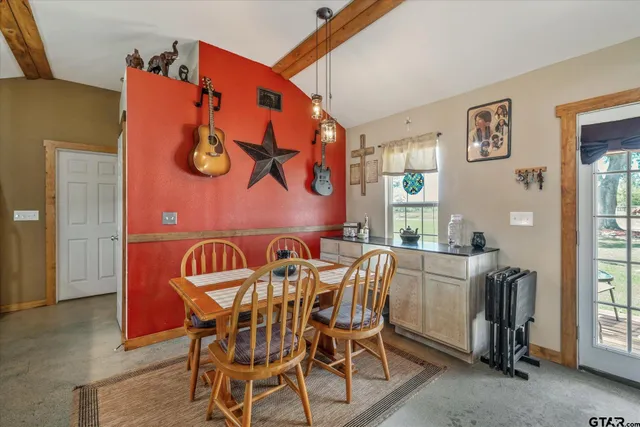 a view of a dining room that has a table and chairs in it