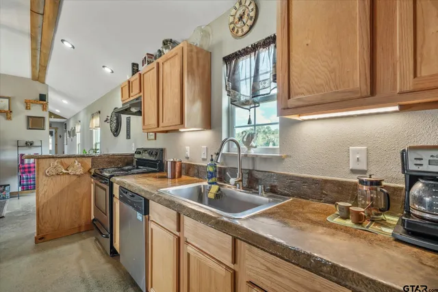 a kitchen with a sink stove and cabinets