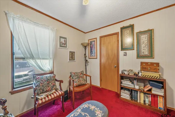 a bedroom with furniture and a book shelf