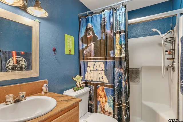 a bathroom with a sink toilet and shower