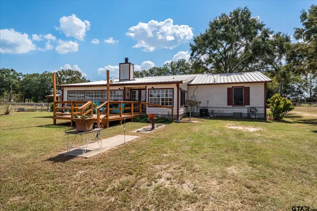 a view of a house with swimming pool and sitting area