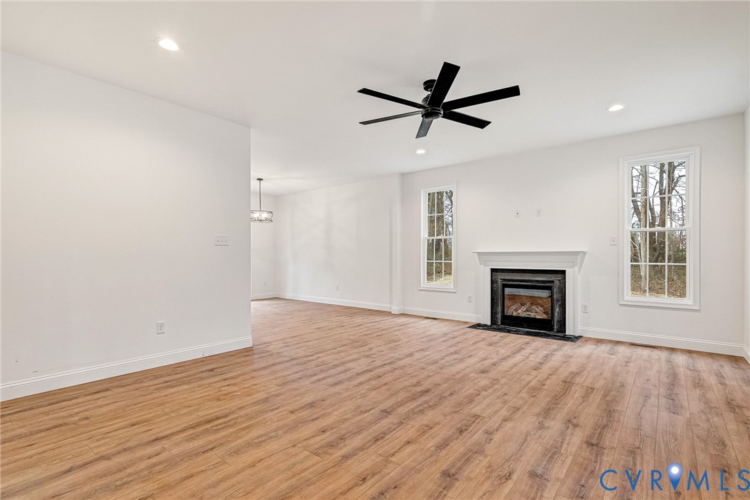 4715 Shannon Hill Road Columbia, VA 23038 - Photo 21 of 52 a view of empty room with wooden floor and fireplace