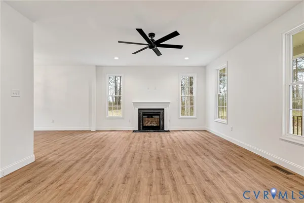 a view of a room window and wooden floor
