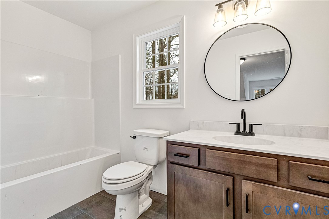 4715 Shannon Hill Road Columbia, VA 23038 - Photo 28 of 52 a bathroom with a sink a toilet and a mirror