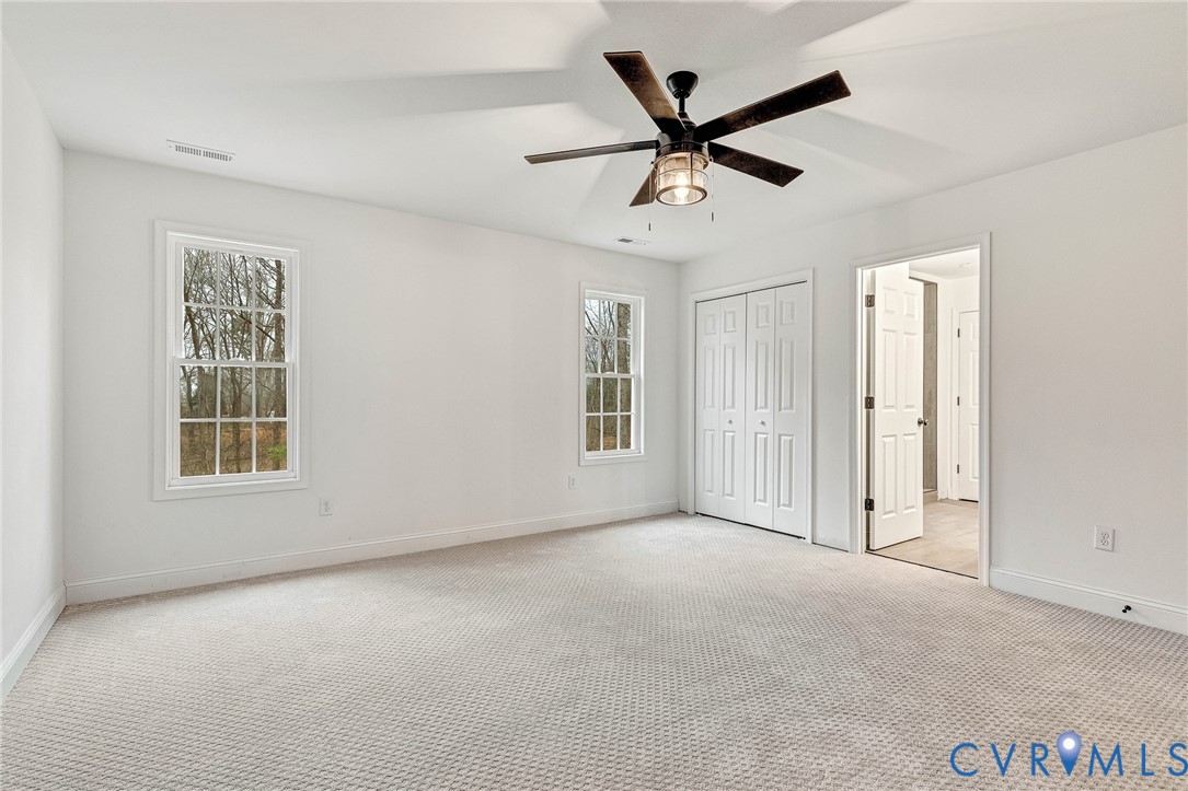 4715 Shannon Hill Road Columbia, VA 23038 - Photo 38 of 52 an empty room with ceiling fan and windows