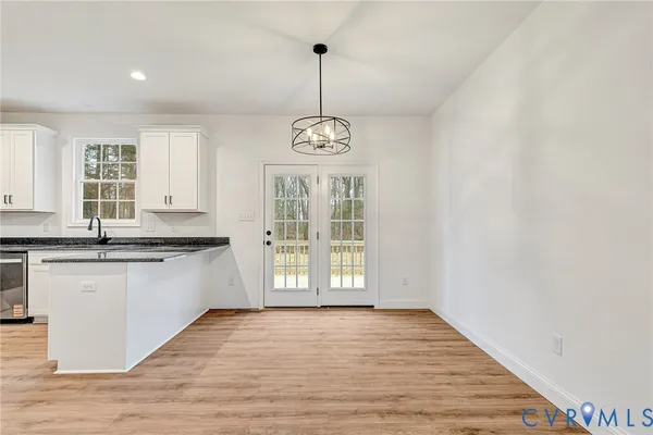 a view of a kitchen with granite countertop wooden floor and a window