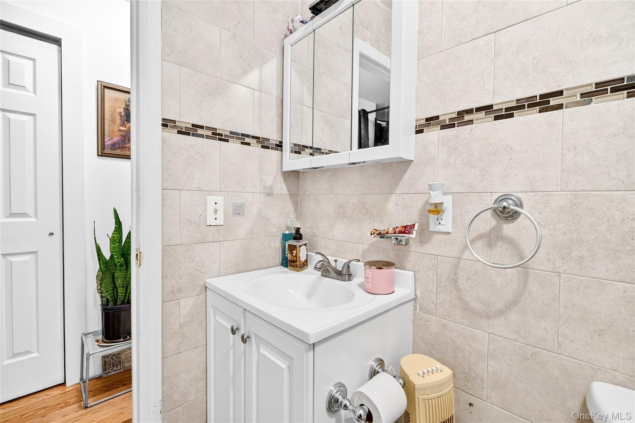 1459 Rosedale Avenue Bronx, NY 10460 - Photo 28 of 37 Bathroom with vanity and tile walls