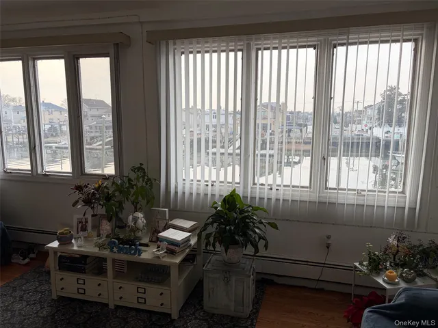 a room with furniture and potted plants