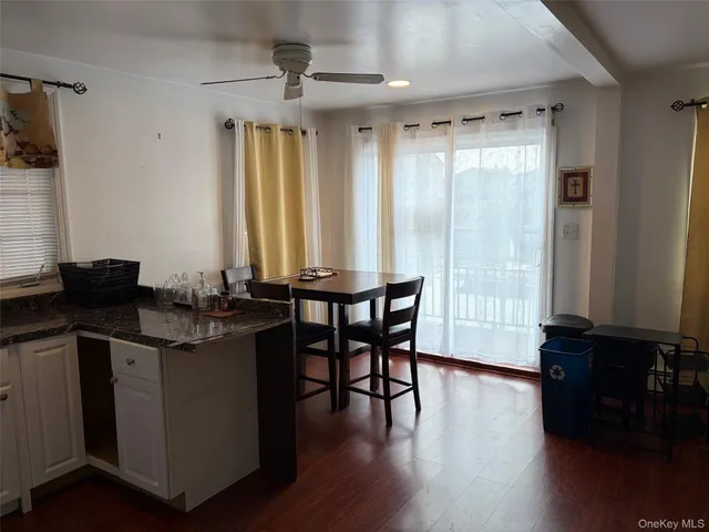 a view of a kitchen with granite countertop a sink and wooden floor