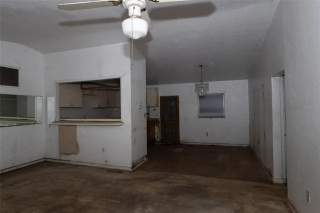 a view of a livingroom with a ceiling fan and window