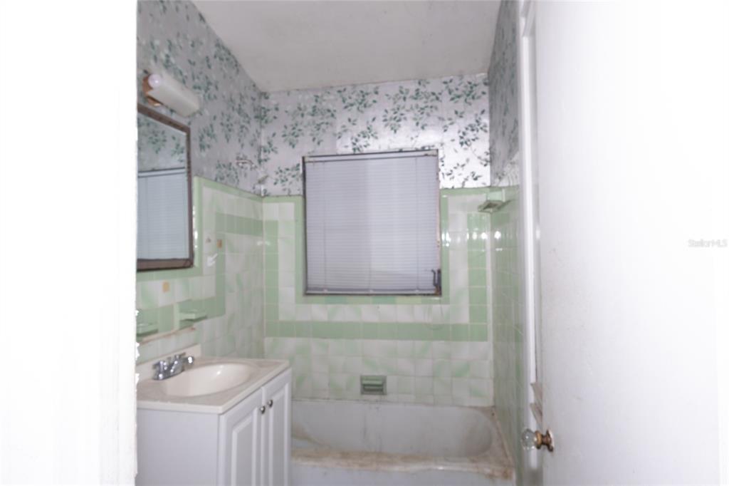 4711 Rio Grande Avenue Orlando, FL 32839 - Photo 35 of 38 a bathroom with a sink and a mirror