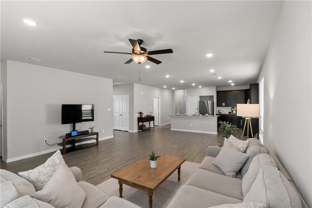 1925 Viva Road Bryan, TX 77807 - Photo 8 of 24 a living room with furniture and a flat screen tv