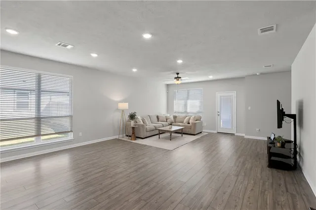a kitchen with sink and view of living room