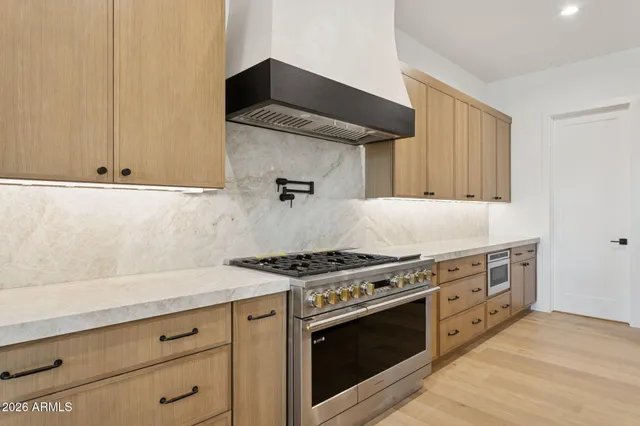 a stove top oven sitting inside of a kitchen