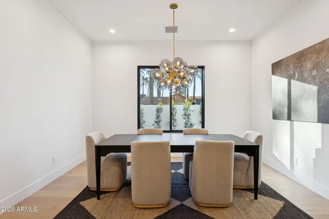 a dining room with furniture a chandelier and window