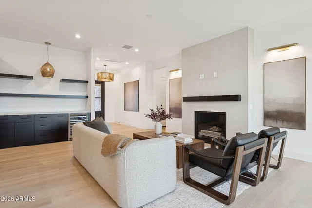 a living room with furniture a fireplace and a table