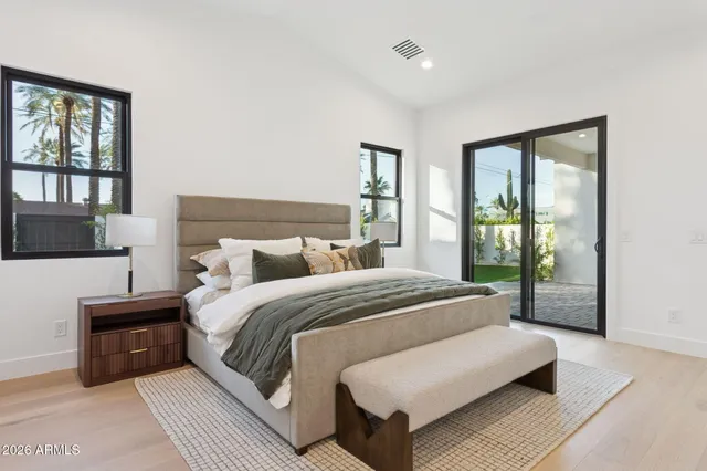 a bedroom with a large bed and a large window