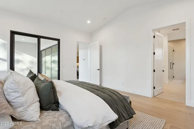 a spacious bedroom with a bed and a large window