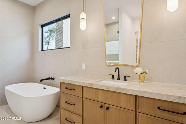 a bathroom with a bathtub sink and mirror