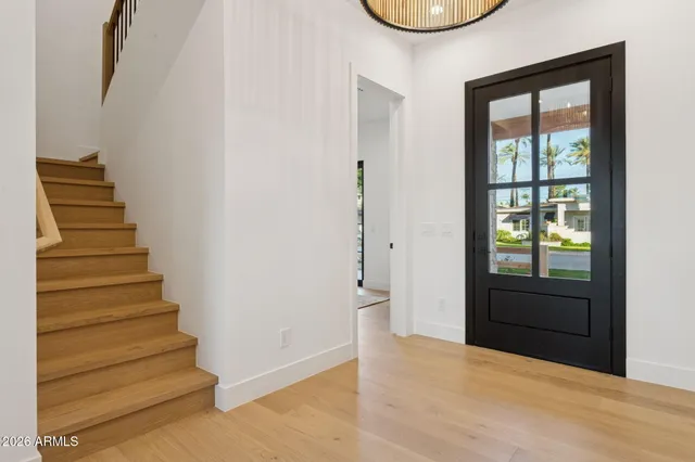 a view of an entryway with wooden floor and door