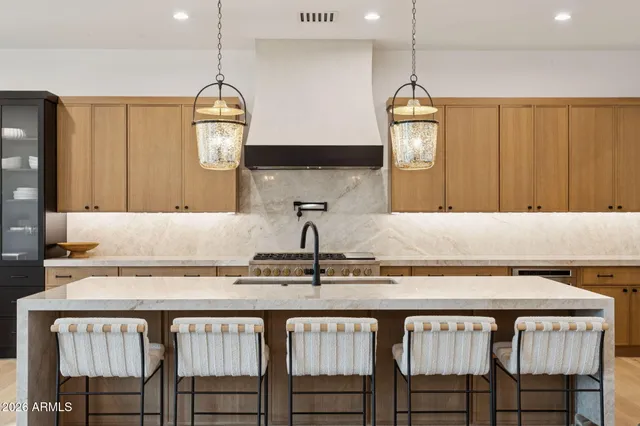 a kitchen with a table chairs sink and stove