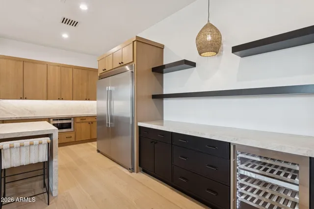 a kitchen with a refrigerator and a stove top oven
