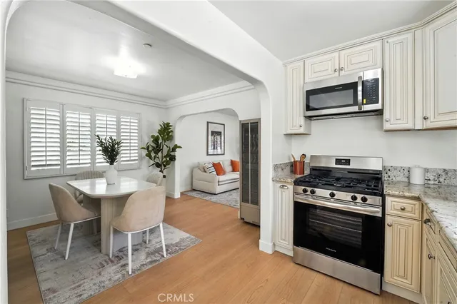 a kitchen with stainless steel appliances a stove a sink and a microwave