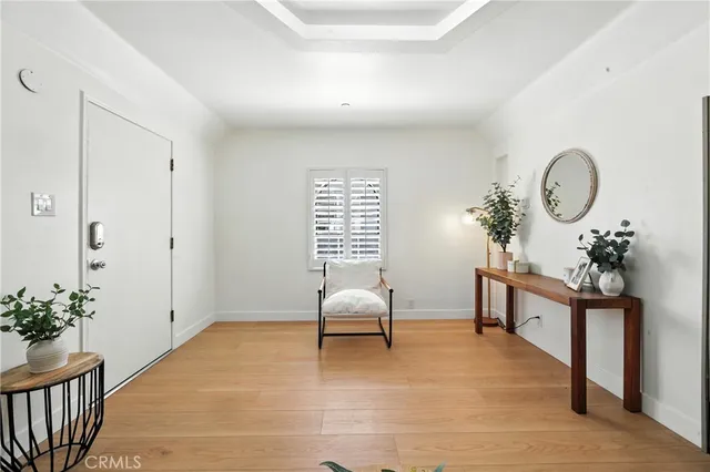 a living room with furniture flowerpot and window